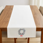 Wreath Motif Table Runner by ILISAH in red, featuring acorn embroidery and a festive design, perfect for Christmas table s...